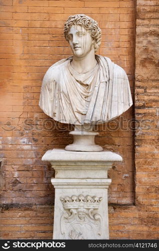Carved Bust In Front of Brick Wall