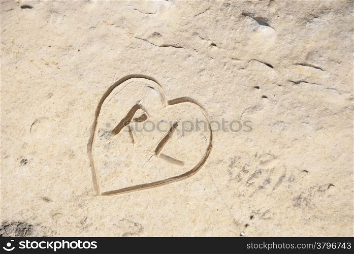 Carved heart with initials in the rock