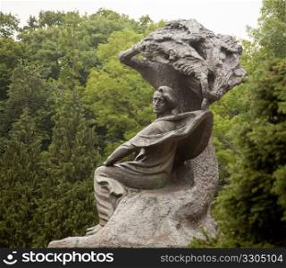 Carved statue of Frederick Chopin in Royal Park in Warsaw Poland