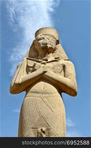 Carved statue of pharaoh Ramses II situated at Karnak Temple complex, Luxsor, Egypt