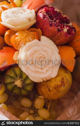 Carved vfruit bouquet, original creative food present, dessert. Carved fruit bouquet