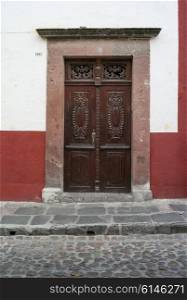 Carved wooden entrance door of a house, San Miguel de Allende, Guanajuato, Mexico