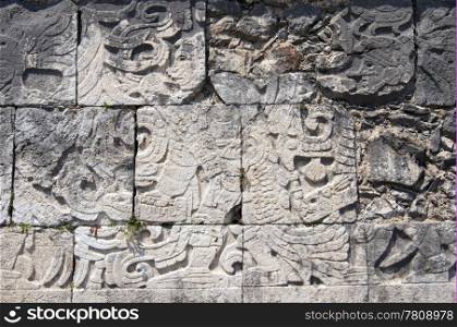 Carvings on the stone of temple in Chichen Itza, Yucatan, Mexico