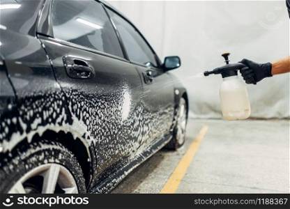 Carwash service, cleaning the wheels with a special agent. Auto detailing, washing with spray. Carwash, cleaning the wheels with a special agent