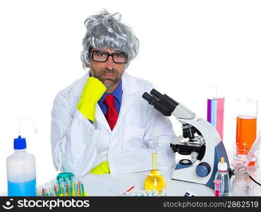 Carzy pensive nerd scientist at chemical laboratory thinking with microscope