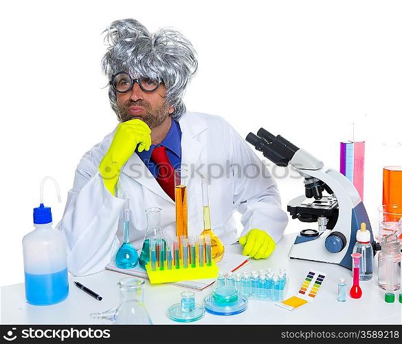 Carzy pensive nerd scientist at chemical laboratory thinking with microscope