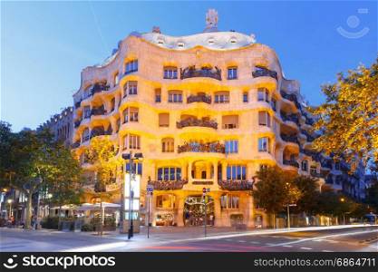 Casa Mila at night, Barcelona, Spain. Barcelona, Catalonia, Spain - July 7, 2017: Casa Mila better known as La Pedrera during evening blue hour, it is the last private residence designed by architect Antoni Gaudi