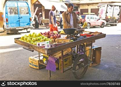CASABLANCA, MOROCCO - OCTOBER 16 2013: Merchant is selling fruits in the streets of Casablanca Morocco
