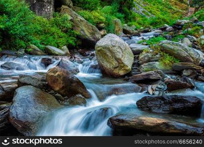 Cascade of tropical waterfall in Himalayas. Bhagsu, Himachal Pradesh, India. Polarizer filter used. Tropical waterfall. Bhagsu, Himachal Pradesh, India