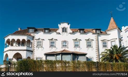 Cascais, Portugal - August 30, 2019: Facade of whitewashed historic villa in the historic centre of Cascais, Portugal. Facade of whitewashed historic villa in the historic centre of Cascais, Portugal