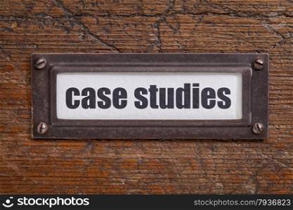 case studies - file cabinet label, bronze holder against grunge and scratched wood