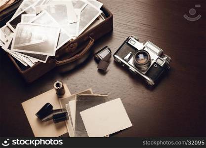 Case with old black and white photographs, film camera and film reels; blank card on foreground (all photos are mine)