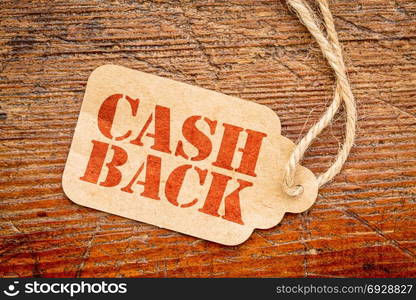 cash back sign - red stencil text on a cardboard price tag against rustic wood