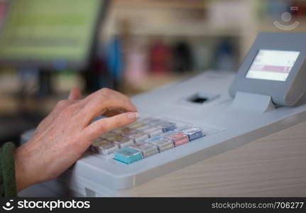 Cash register in a shop: Customer is paying purchase