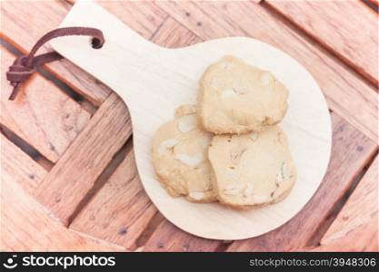 Cashew cookies on wooden plate, stock photo