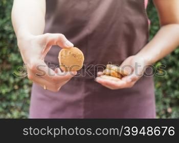 Cashew nut cookies on hand of baker, stock photo