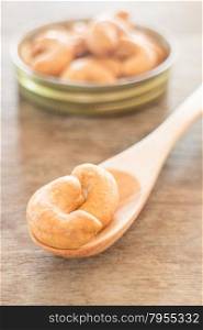 Cashew nut roast salt on weathered wooden table, stock photo