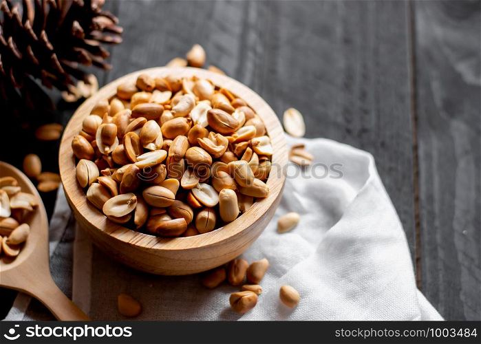 Cashew nuts are placed on a white wooden table.