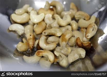 Cashew nuts frying for inclusion in an Indian pilaf rice dish, Shallow depth of field.