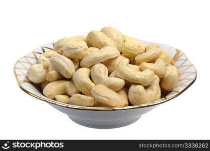 Cashew nuts in a white plate on a white background, isolated