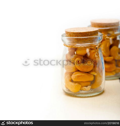 cashew nuts on a glass jar over white rustic wood table