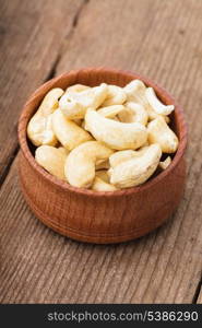 cashews in a wooden bowl on the table