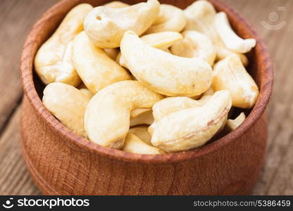 cashews in a wooden bowl on the table