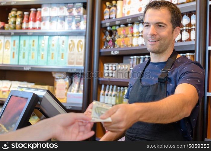 Cashier handing notes to customer