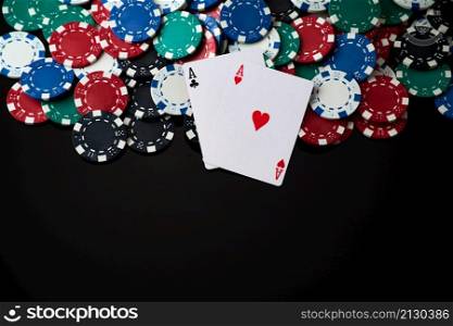 Casino chips and playing cards on dark reflective background.. Casino chips and playing cards on dark reflective background