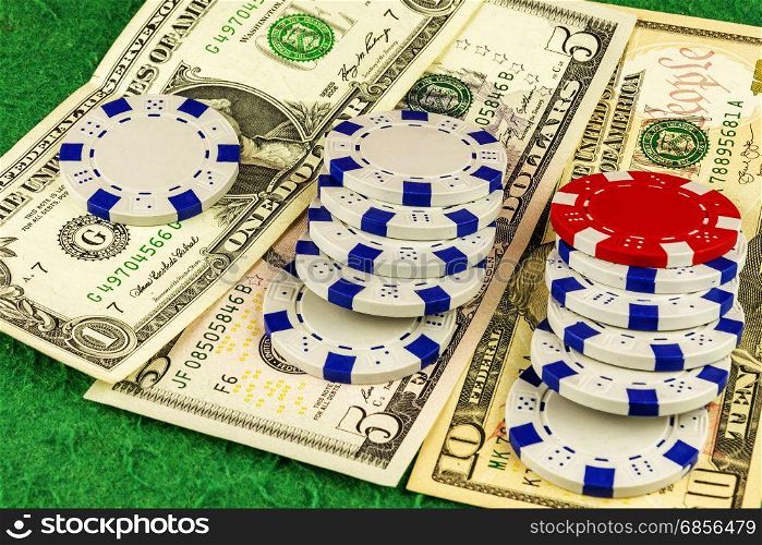 Casino chips lie on the respective denominations of banknotes