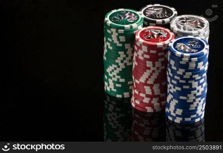 Casino chips on a black background with reflection. The concept of gambling and entertainment. Casino and poker. gambling poker, closeup