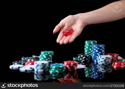 Casino chips, playing cards and dices on dark reflective background.. Casino chips, playing cards and dices on dark reflective background