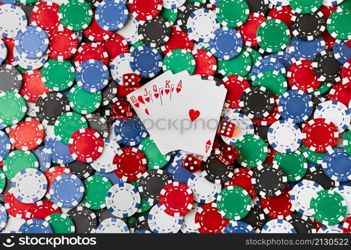 Casino chips, playing cards and dices on green fabric table.. Casino chips, playing cards and dices on green fabric table