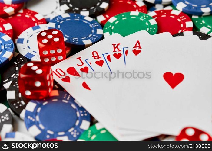 Casino chips, playing cards and dices on green fabric table.. Casino chips, playing cards and dices on green fabric table