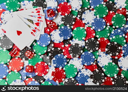 Casino chips, playing cards and dices on green fabric table.. Casino chips, playing cards and dices on green fabric table