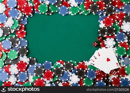 Casino chips, playing cards and dices on green fabric table.. Casino chips, playing cards and dices on green fabric table