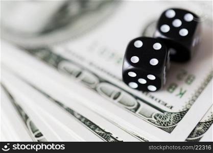 casino, gambling and fortune concept - close up of black dice and dollar cash money