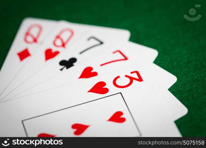 casino, gambling, games of chance, hazard and entertainment concept - poker hand of playing cards on green cloth. poker hand of playing cards on green casino cloth