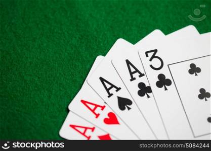 casino, gambling, games of chance, hazard and entertainment concept - poker hand of playing cards on green cloth. poker hand of playing cards on green casino cloth. poker hand of playing cards on green casino cloth