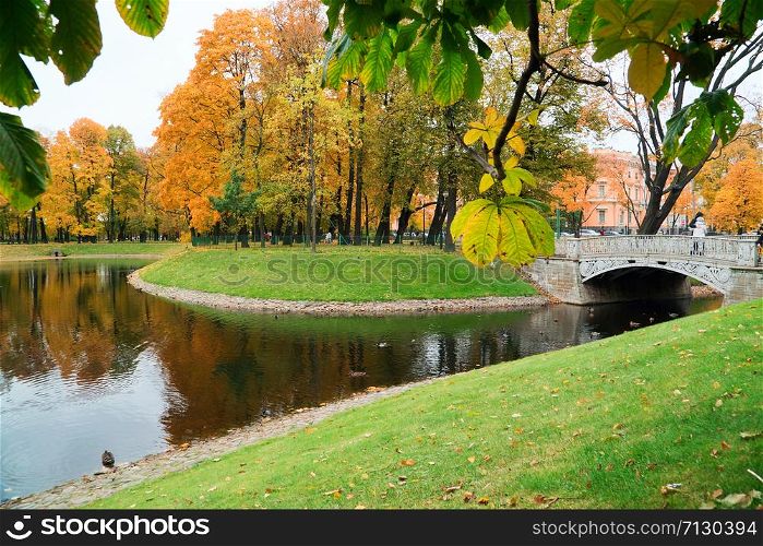 Cast iron bridge in Mikhailovsky Park,.Autumn landscape, St. Petersburg Mikhailovsky castle. Cast iron bridge in Mikhailovsky Park,.Autumn landscape, St. Petersburg, Mikhailovsky castle.