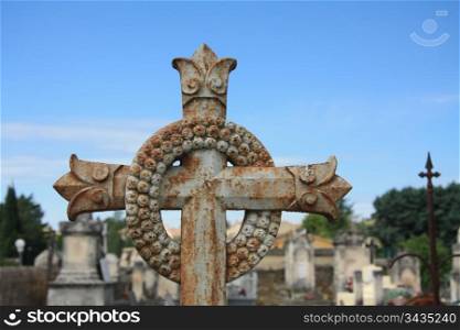 Cast iron grave ornament, cross and wrench on an old cemetery in the Provence, France