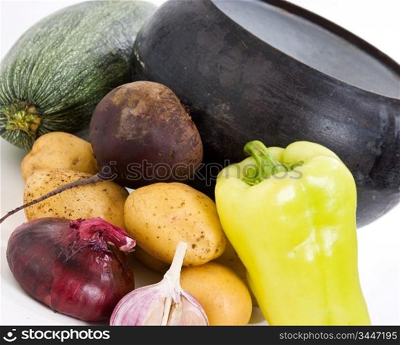 cast iron pot with vegetables isolated on a white background