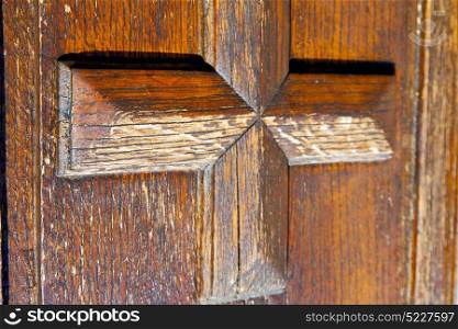 castellanza blur lombardy abstract rusty brass brown knocker in a door curch closed wood italy cross