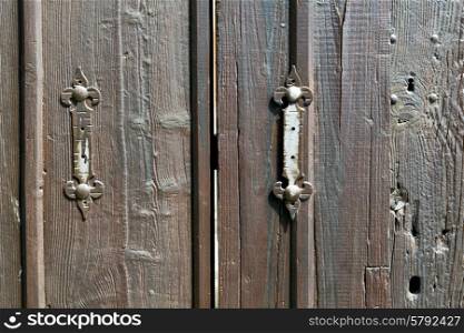 castellanza blur lombardy abstract rusty brass brown knocker in a door curch closed wood italy cross&#xA;