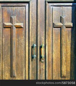 castellanza blur lombardy abstract rusty brass brown knocker in a door curch closed wood italy cross&#xA;