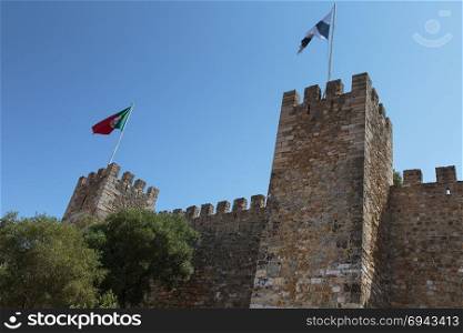 Castle of Sao Jorge: External Wall and Lisbon and Portuguese Flags. Castle of Sao Jorge: External Wall and Lisbon and Portuguese Fla