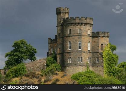 Castle on a hill in Scotland. Shot on an overcast day just as the sun came out behind me and illuminated the castle.