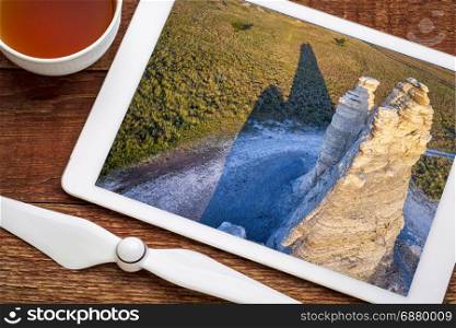 Castle Rock - limestone pillar landmark in prairie of western Kansas near Quinter, revieing aerial image on a digital tablet