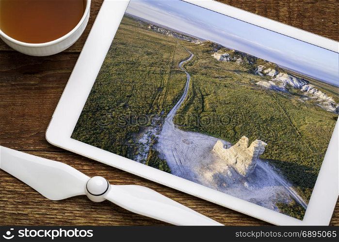 Castle Rock - limestone pillar landmark in prairie of western Kansas, reviewing aerial image on a digital tablet