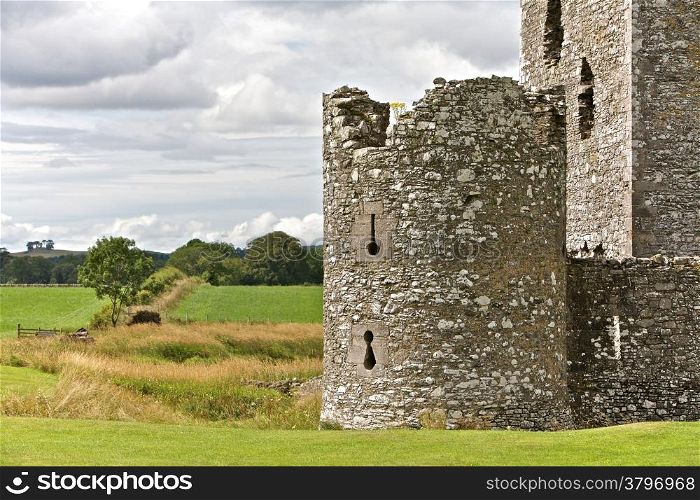Castle Ruins Standing in Green Grasslands. Threave Castle ruins surrounded by pastures in Scotland